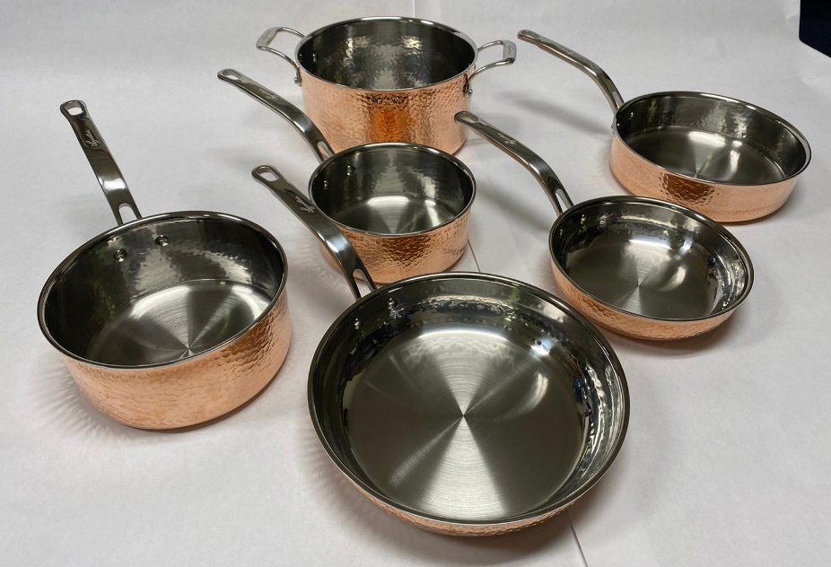 Family of hammered copper pans with stainless interiors