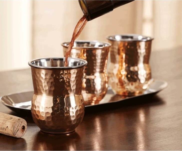 Hammered copper tumblers with grapefruit cocktails