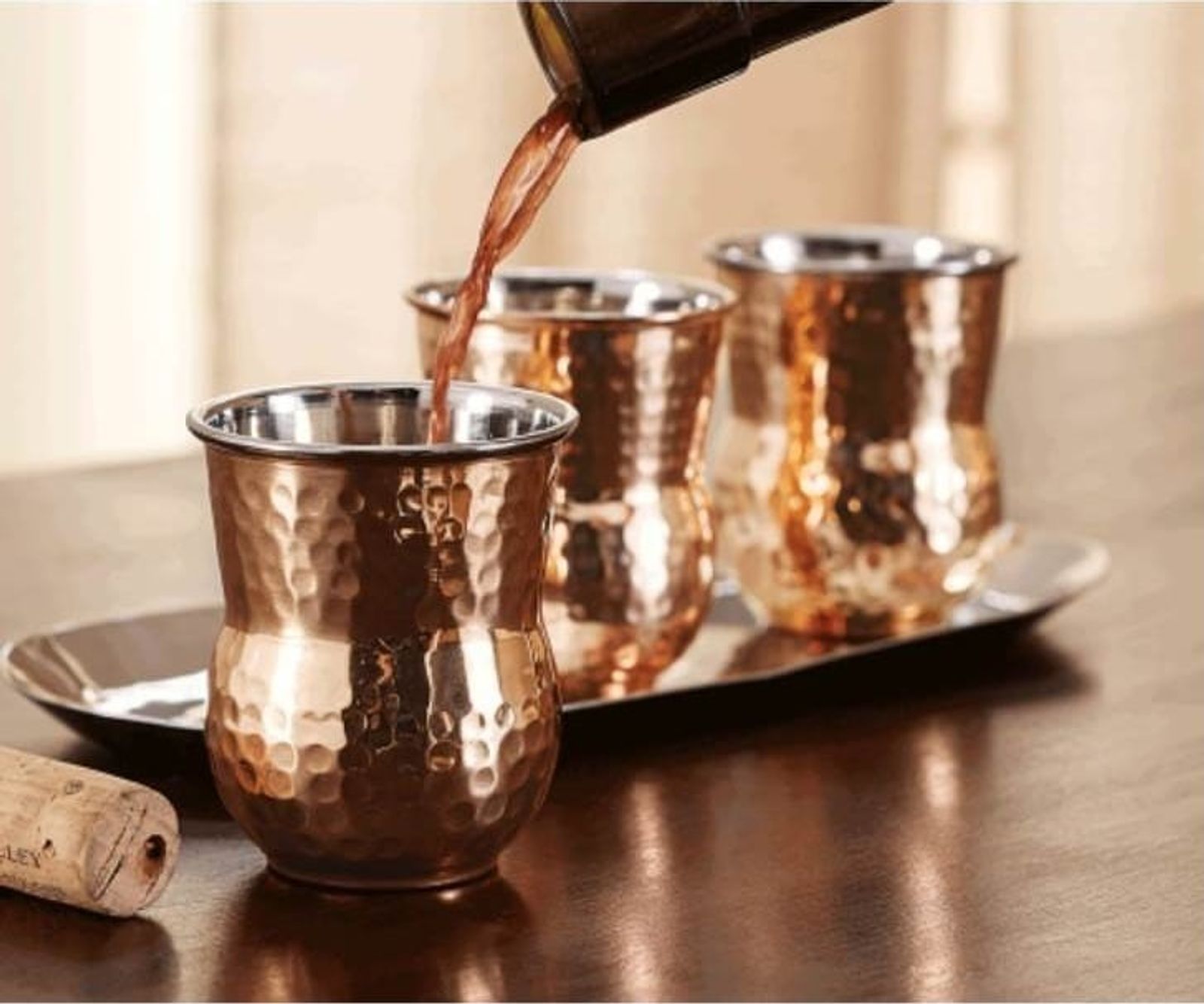 Hammered copper tumblers with grapefruit cocktails
