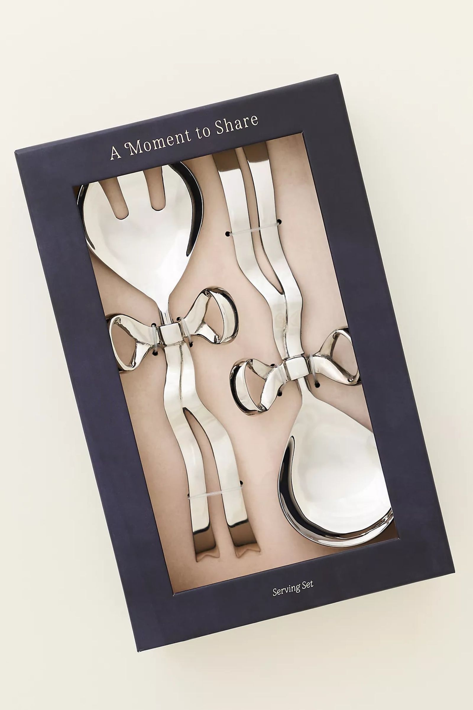 Boxed gift set of silver serving pieces with bow handles