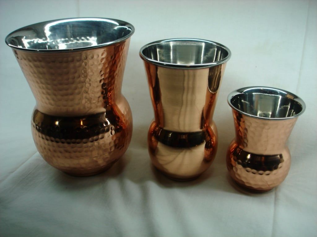 Hammered copper vessels in graduated sizes