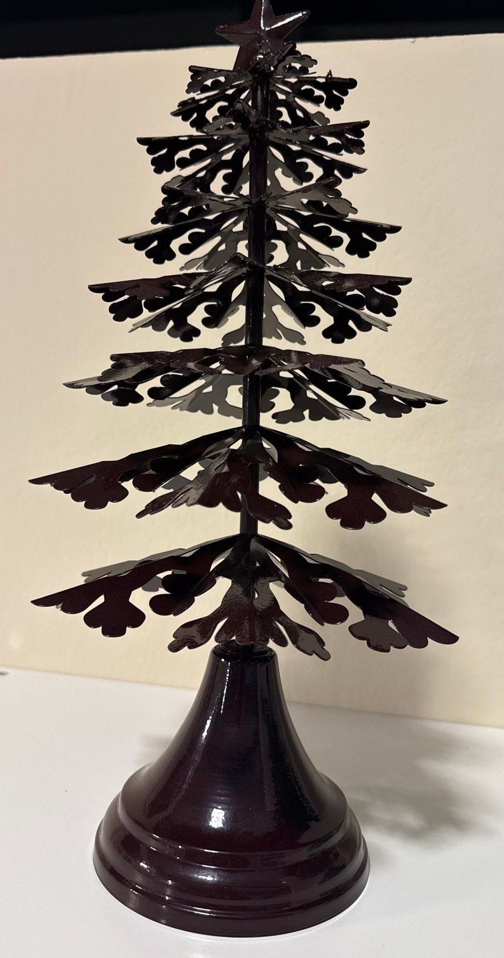 Metal galvanized-steel Christmas tree with a star finial on a turned base