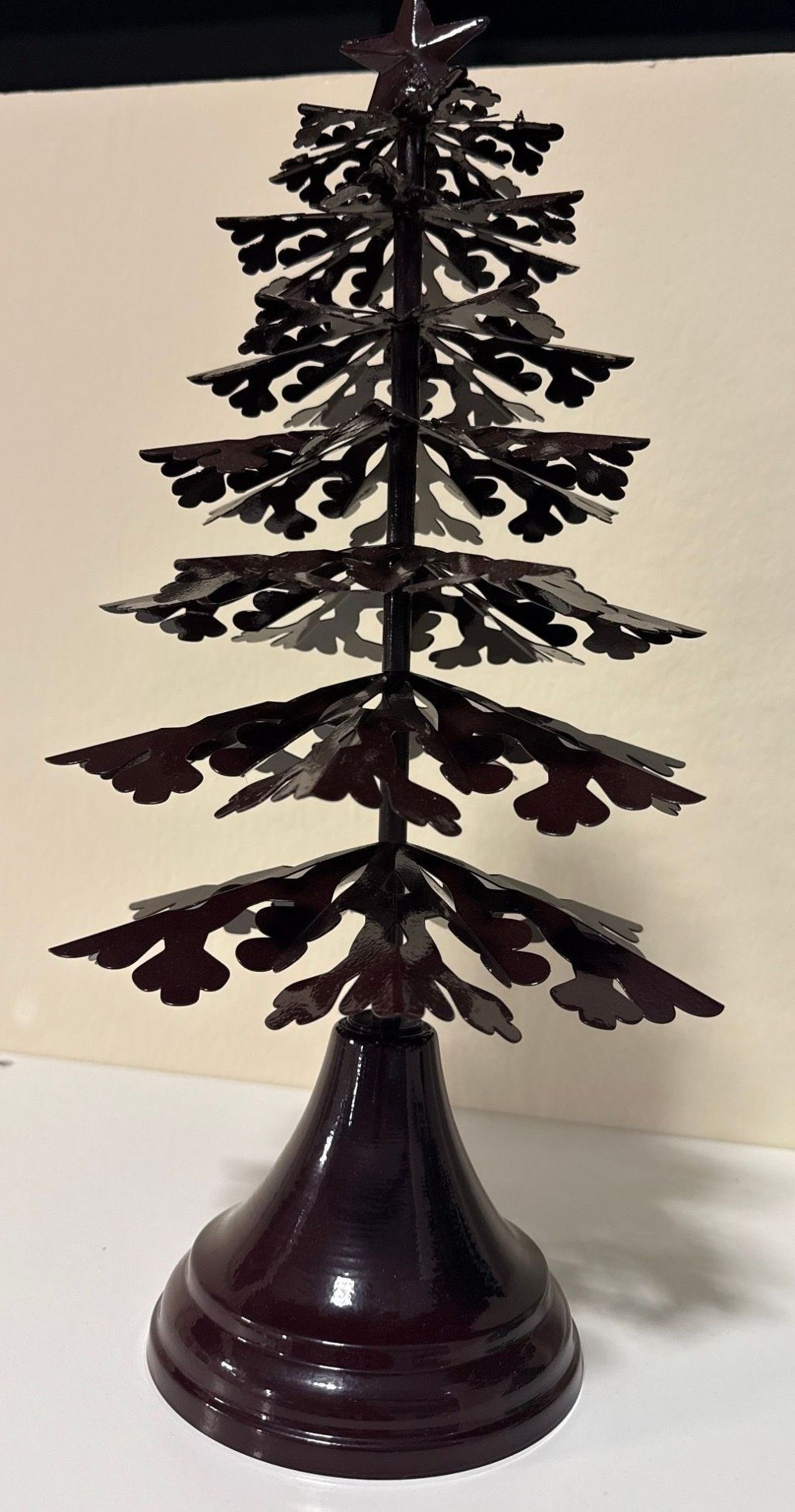 Metal galvanized-steel Christmas tree with a star finial on a turned base