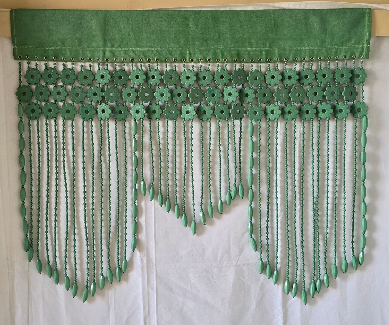 Hand-beaded window valance in green with a scalloped fringe