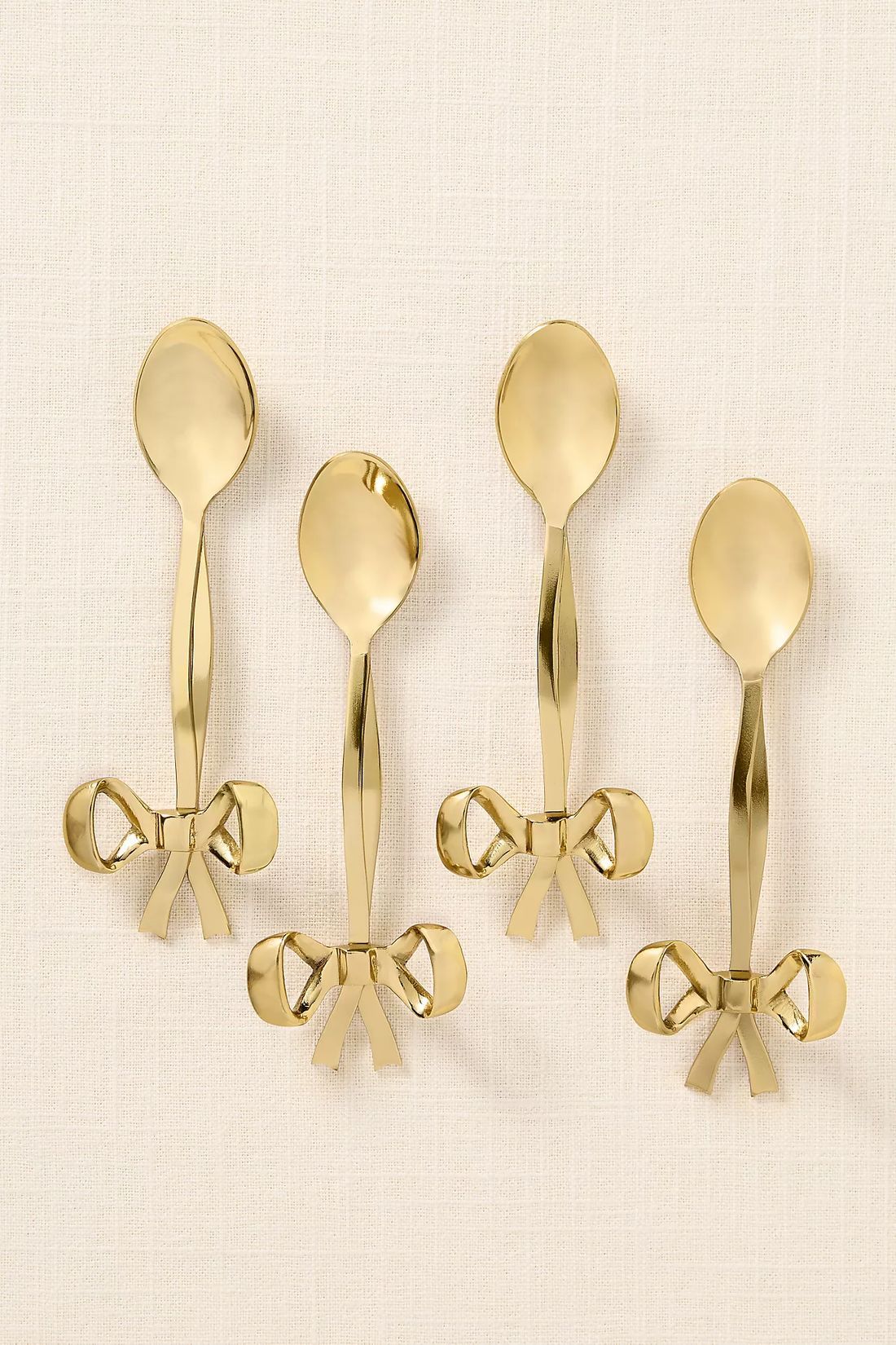 Gold bow-handle dessert spoons, set of four
