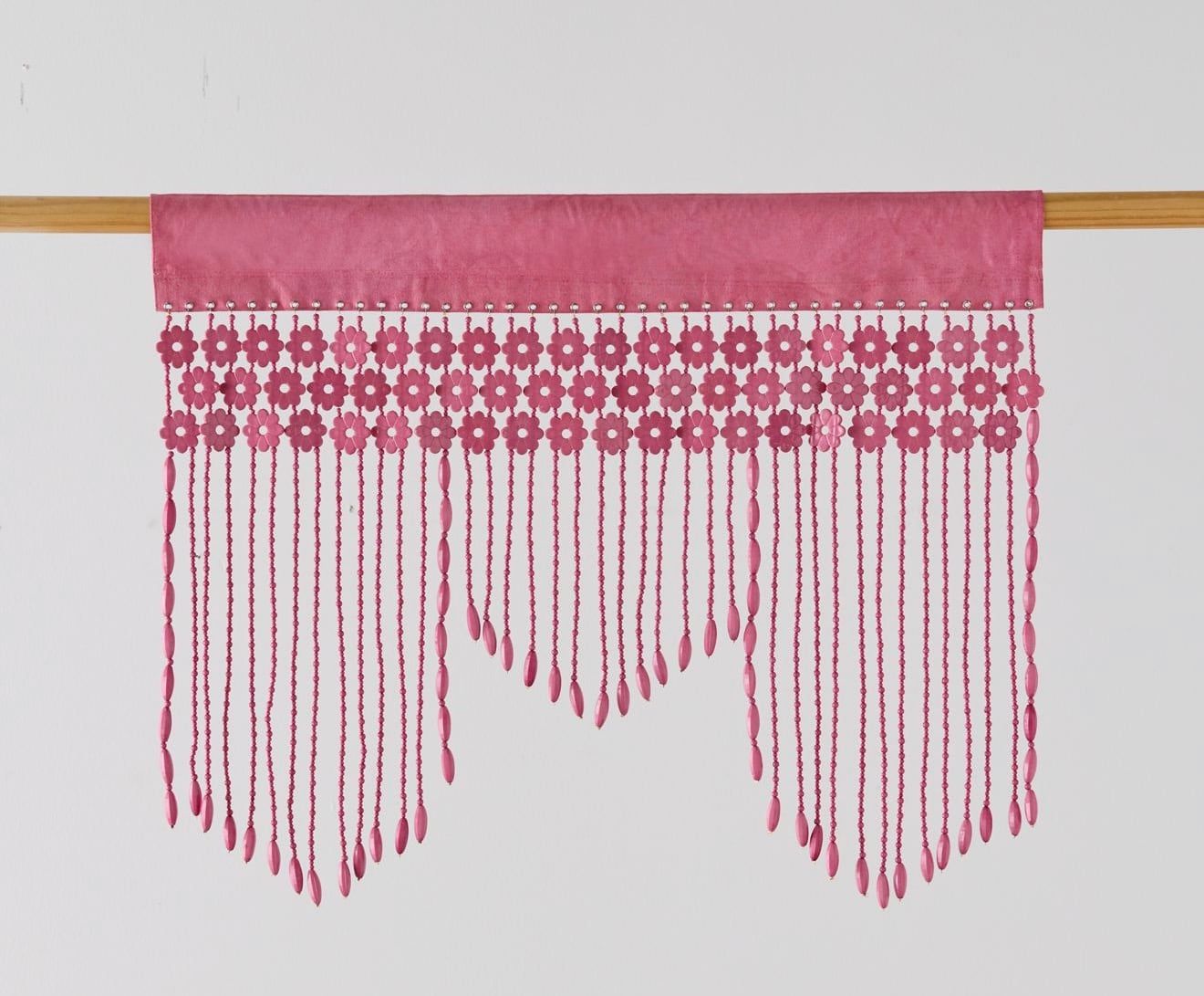 Pink hand-beaded valance on a wooden rod