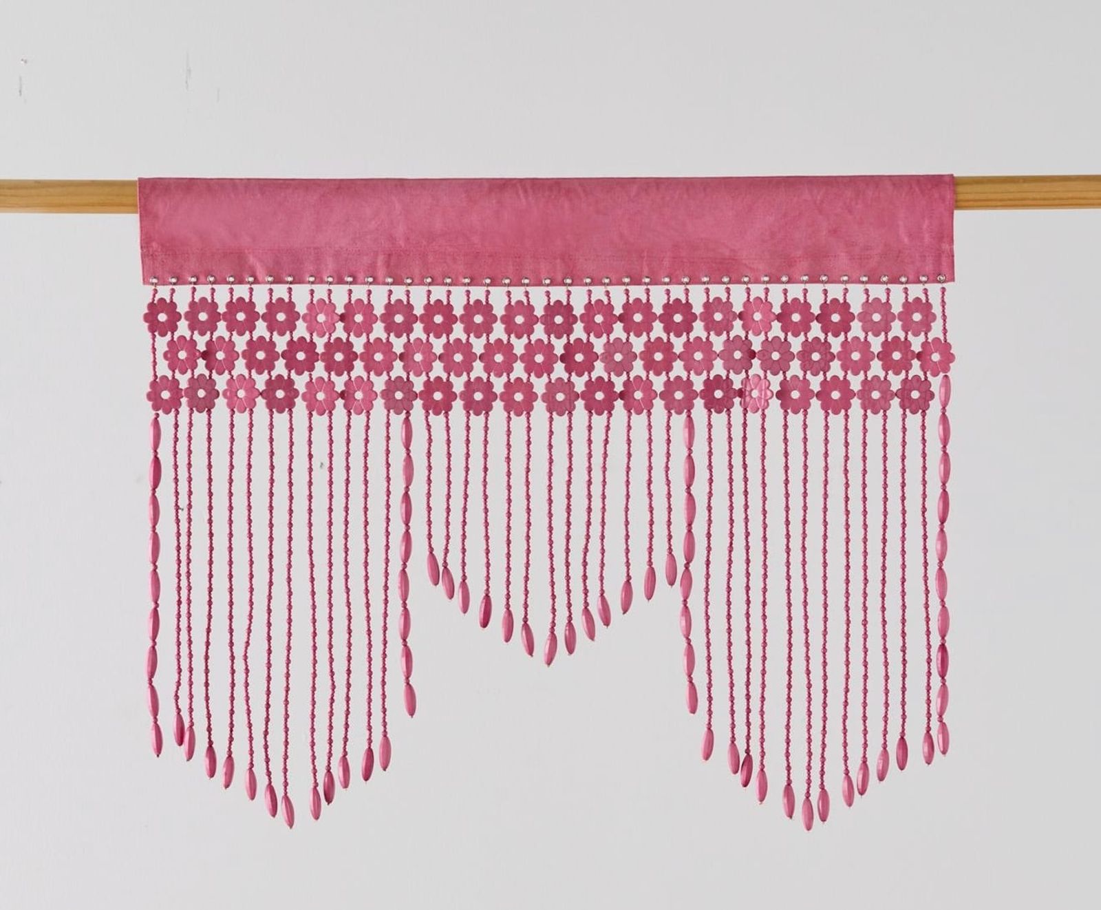 Pink hand-beaded valance on a wooden rod