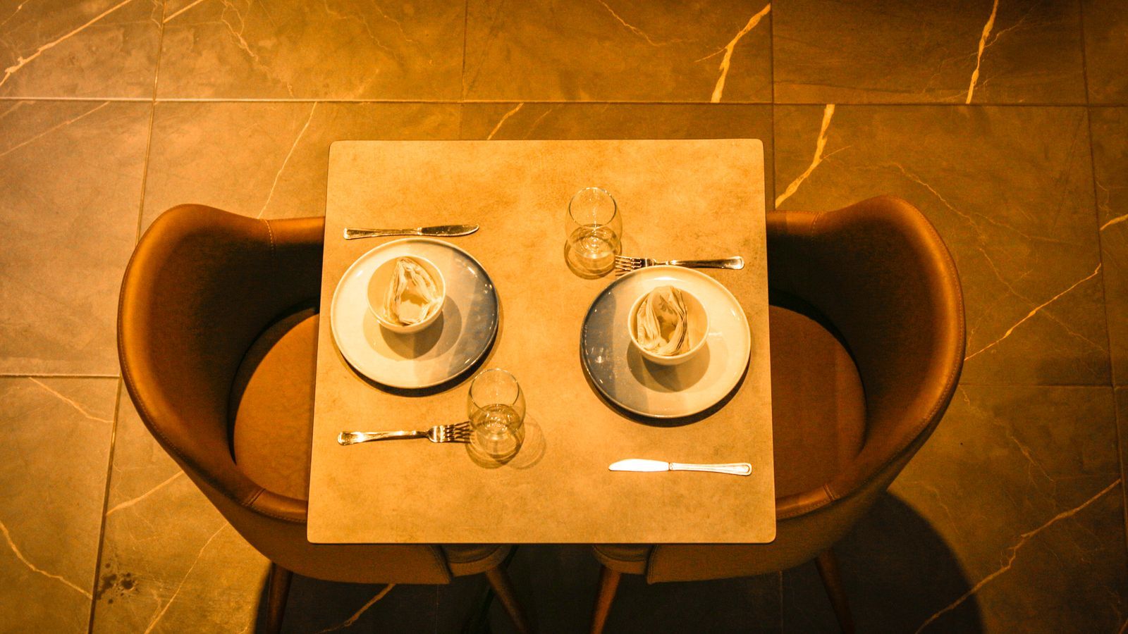 Top-down view of a premium restaurant table with elegant cutlery and fine place settings