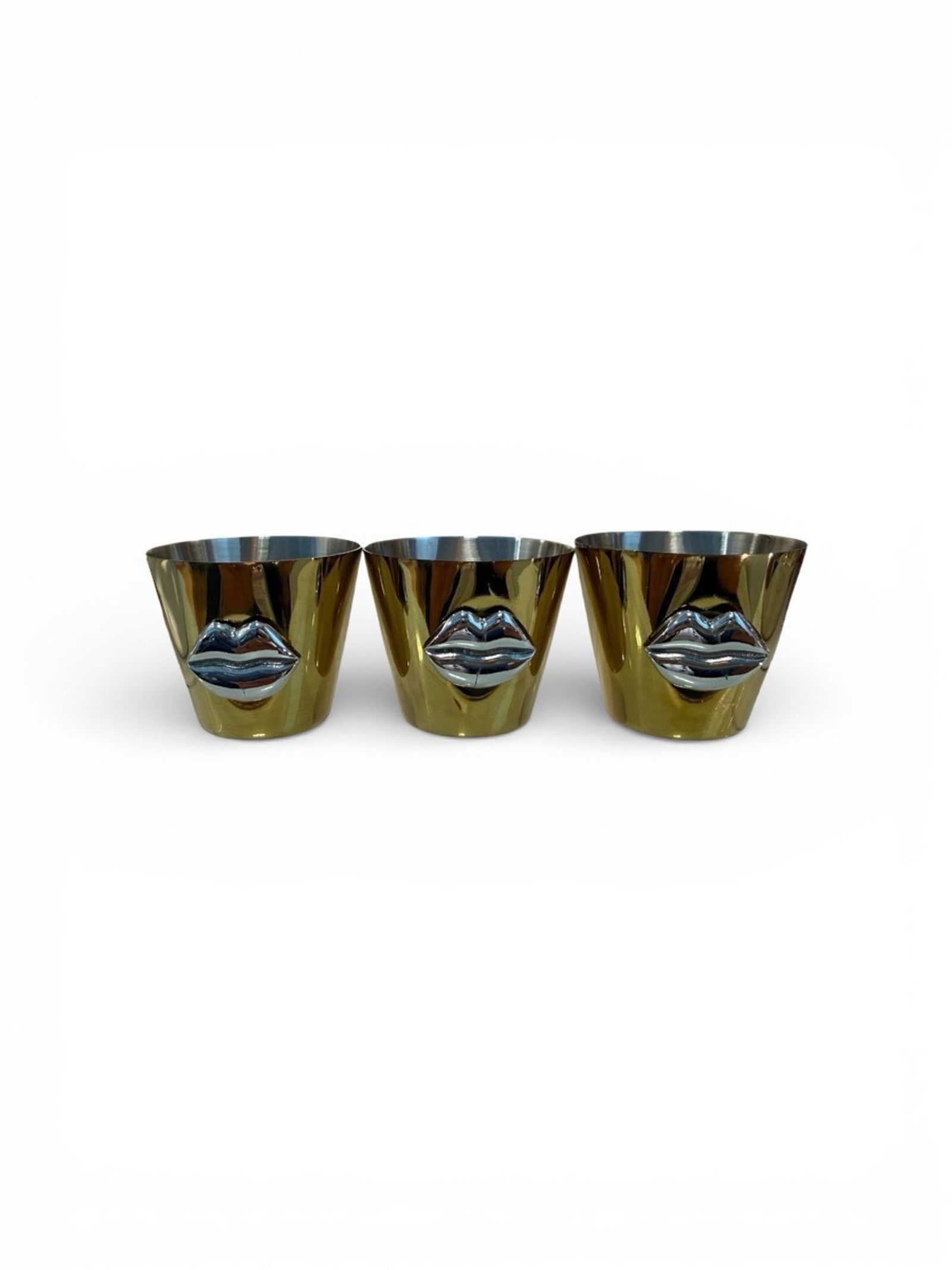 Trio of gold-PVD Icon shot glasses with sculpted silver lips