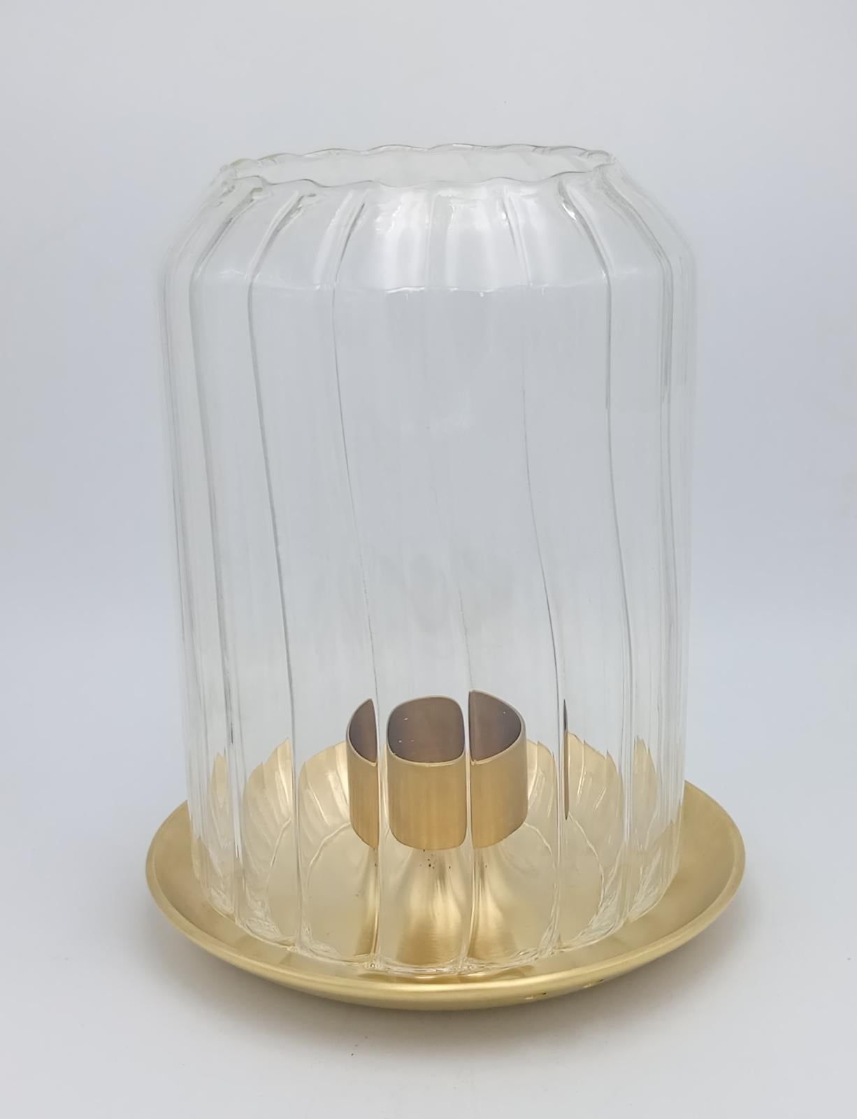 Ribbed glass hurricane on a brass candle plate