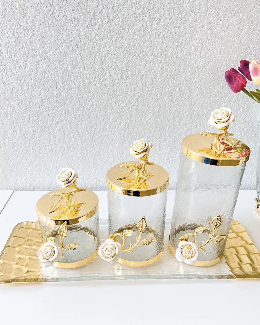 Glass canisters with gold lids and rose finials