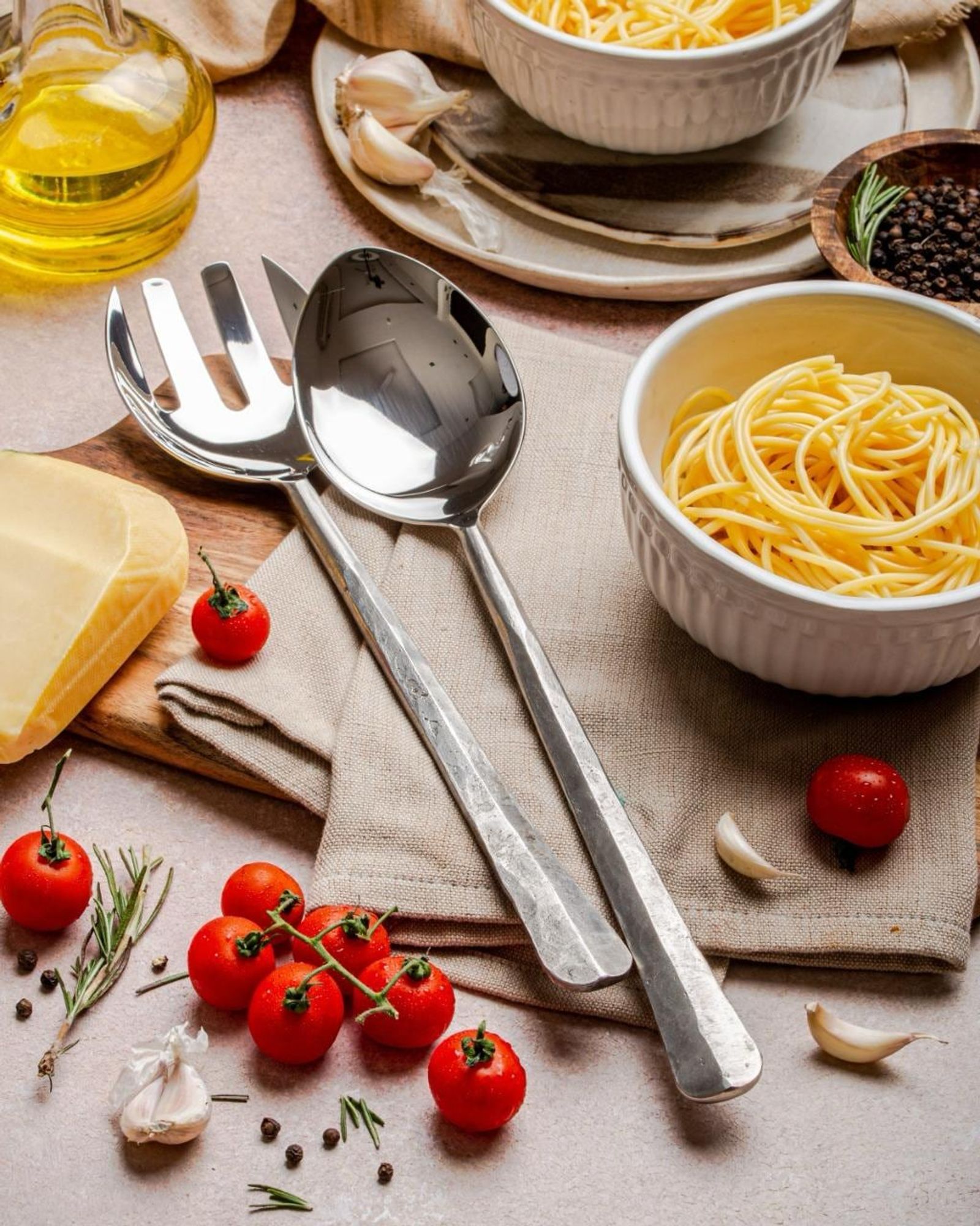 Stainless serving spoon and fork styled on a laid table