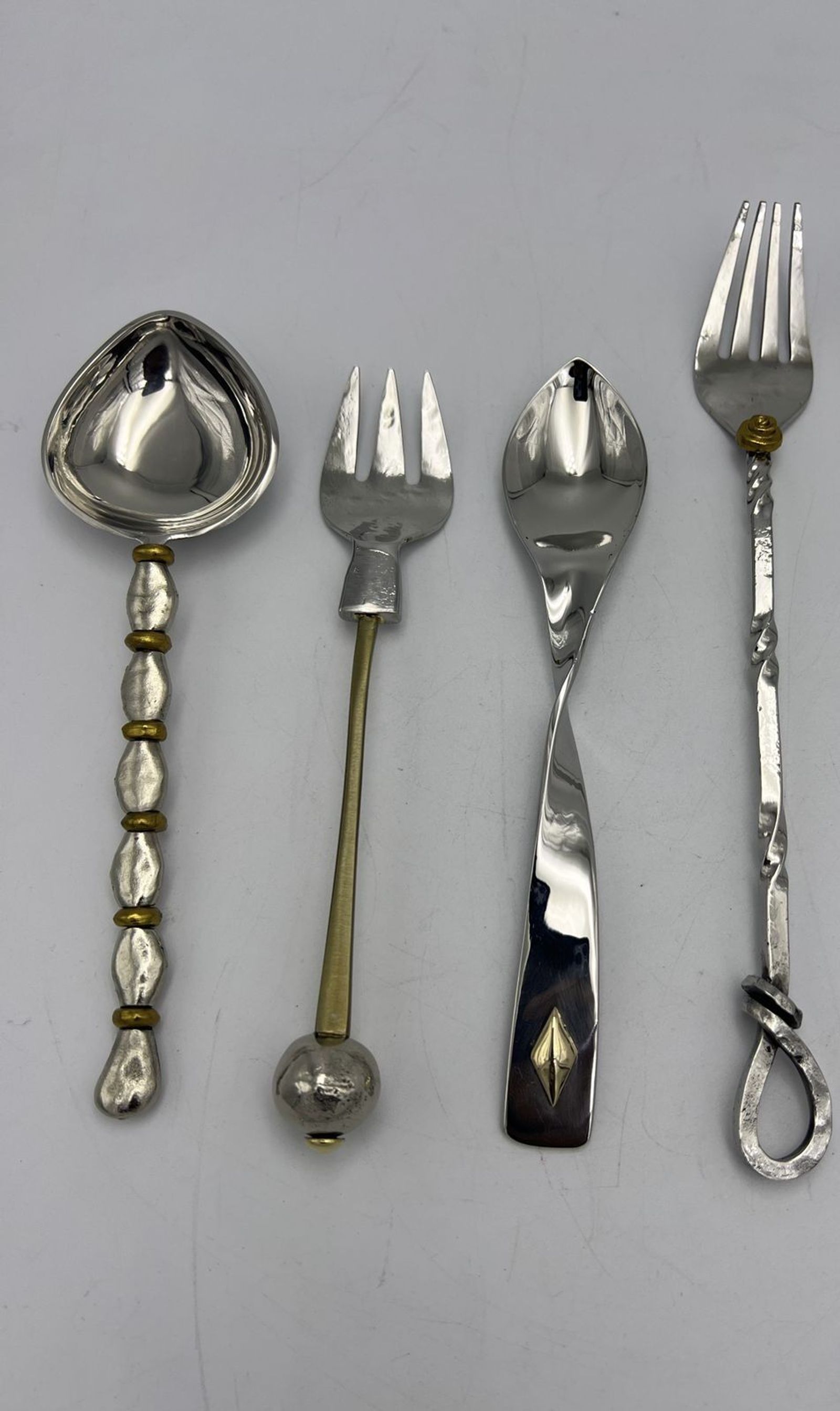Mixed-metal flatware with hammered, beaded and inlaid handles