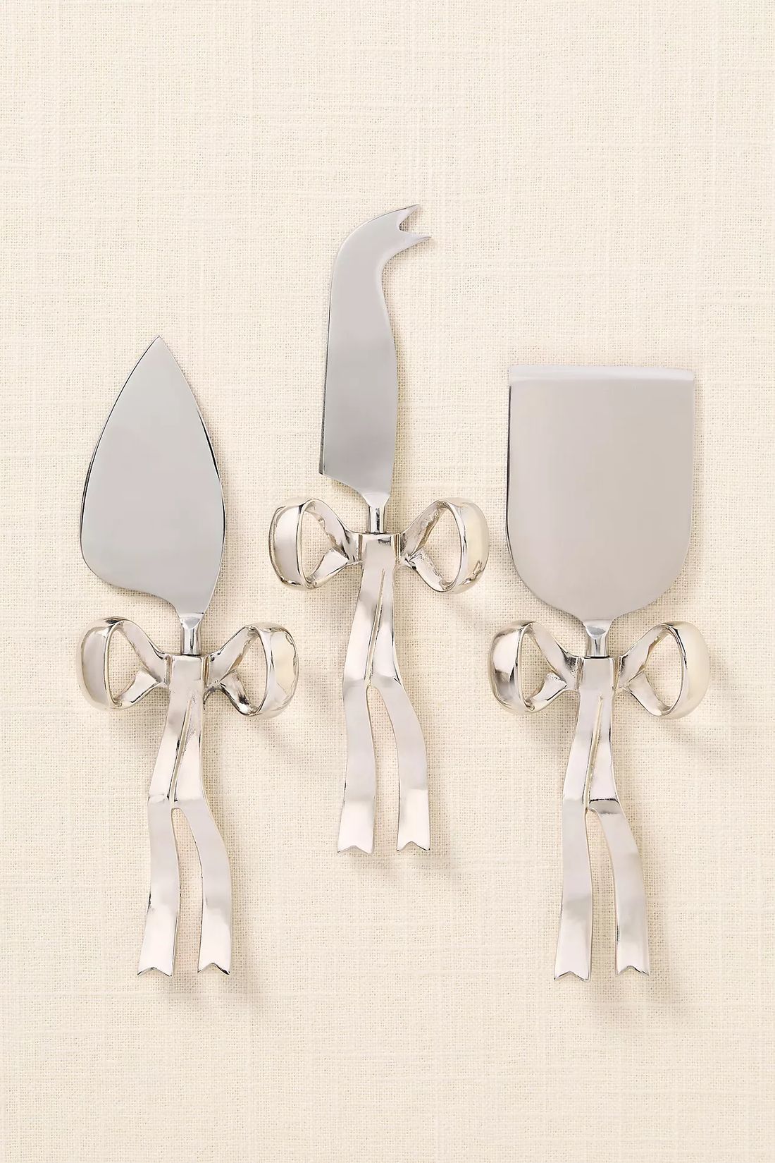 Silver bow-handle cheese tool set