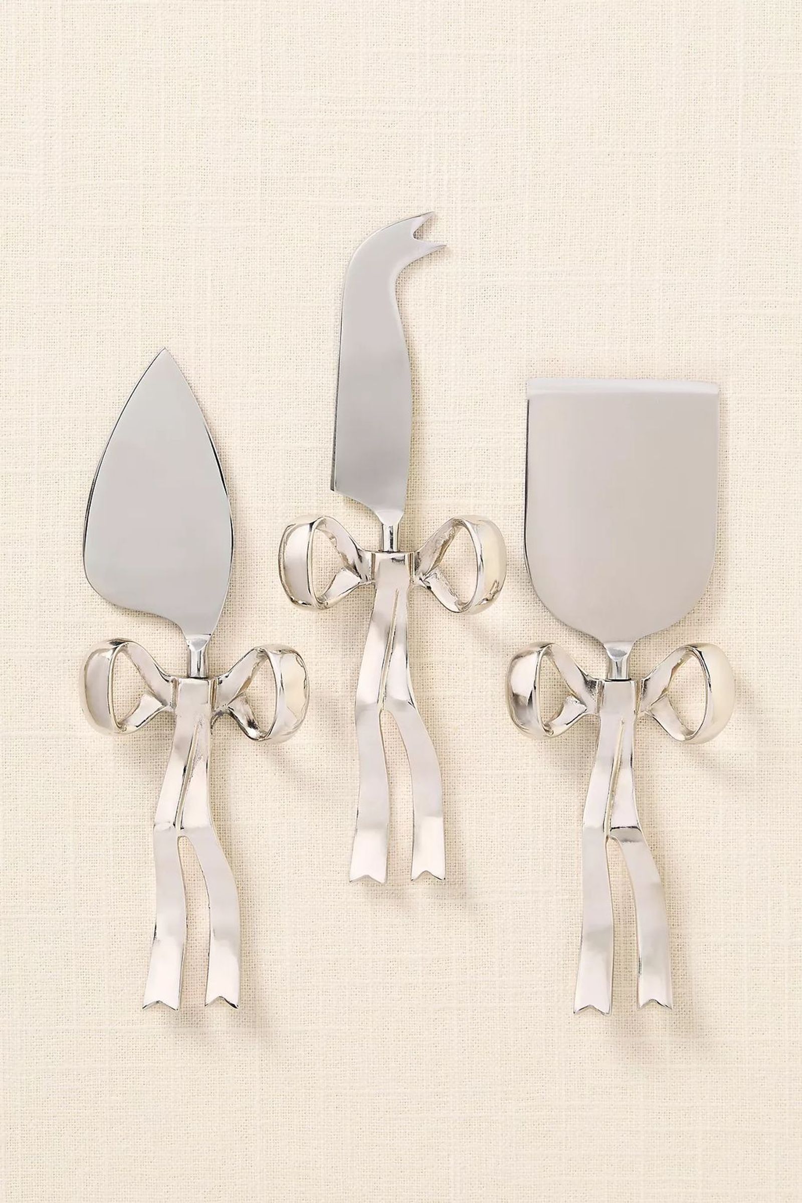 Silver bow-handle cheese tool set