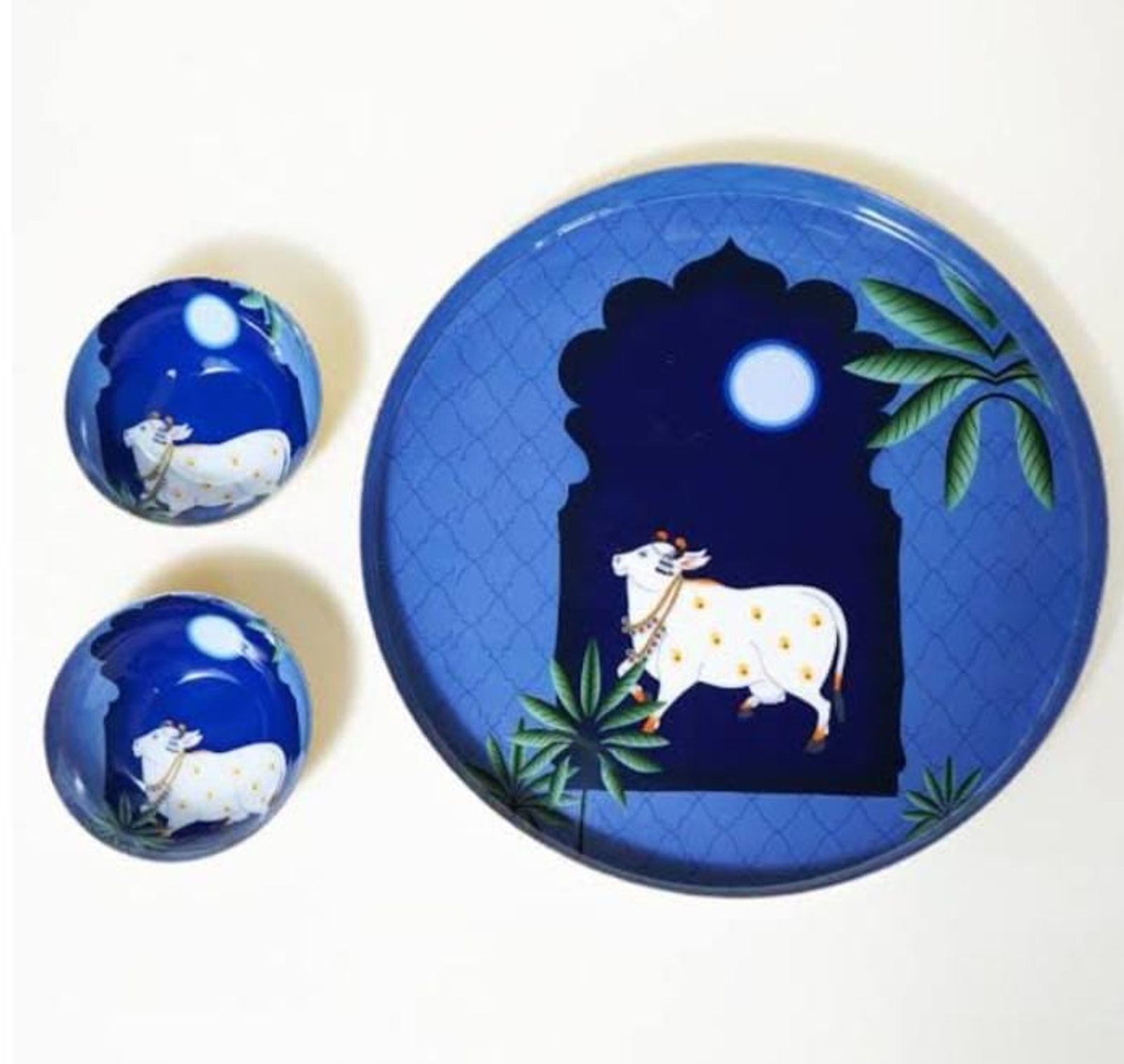 Blue hand-painted ceramic plates with a folk-art motif