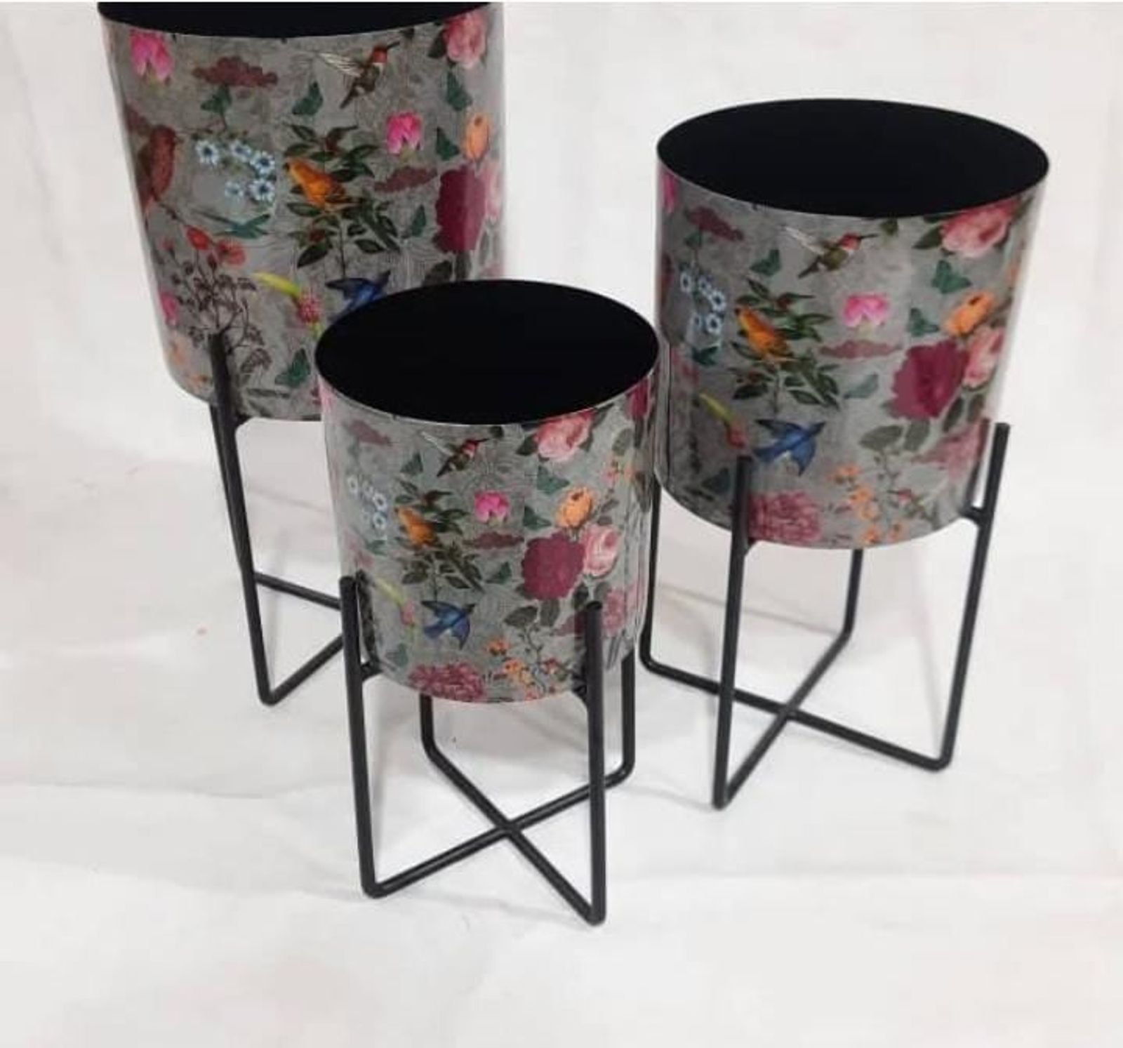 Floral-printed metal planters on black stands