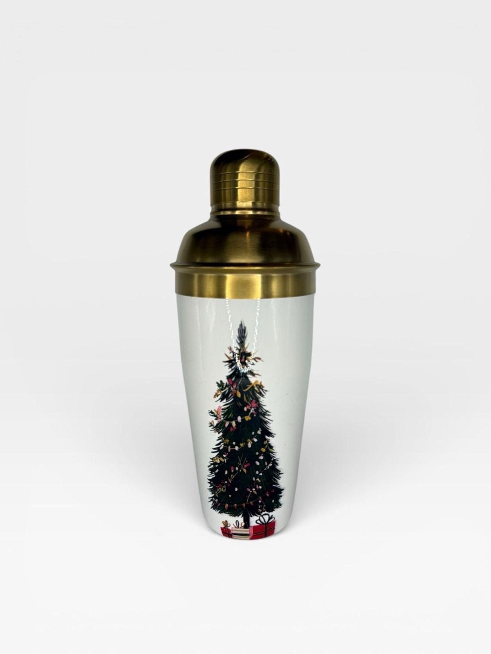 Gold-top cocktail shaker with a printed winter-tree motif