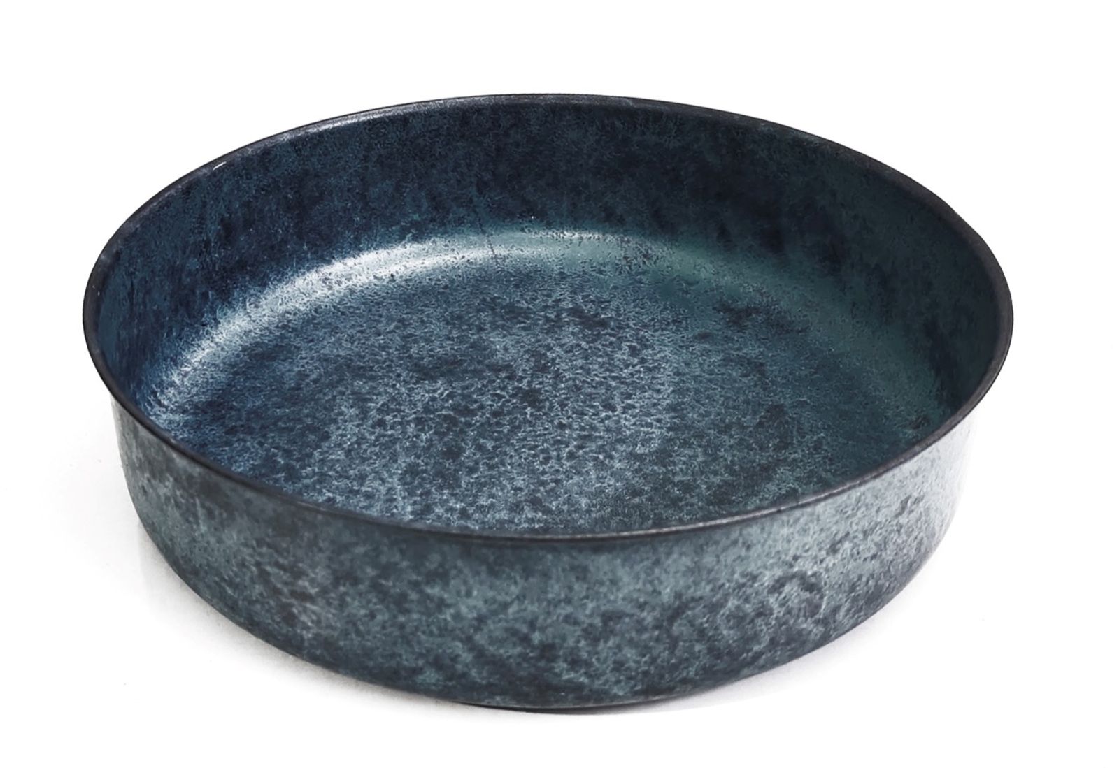 Round galvanized metal tray with a weathered zinc finish