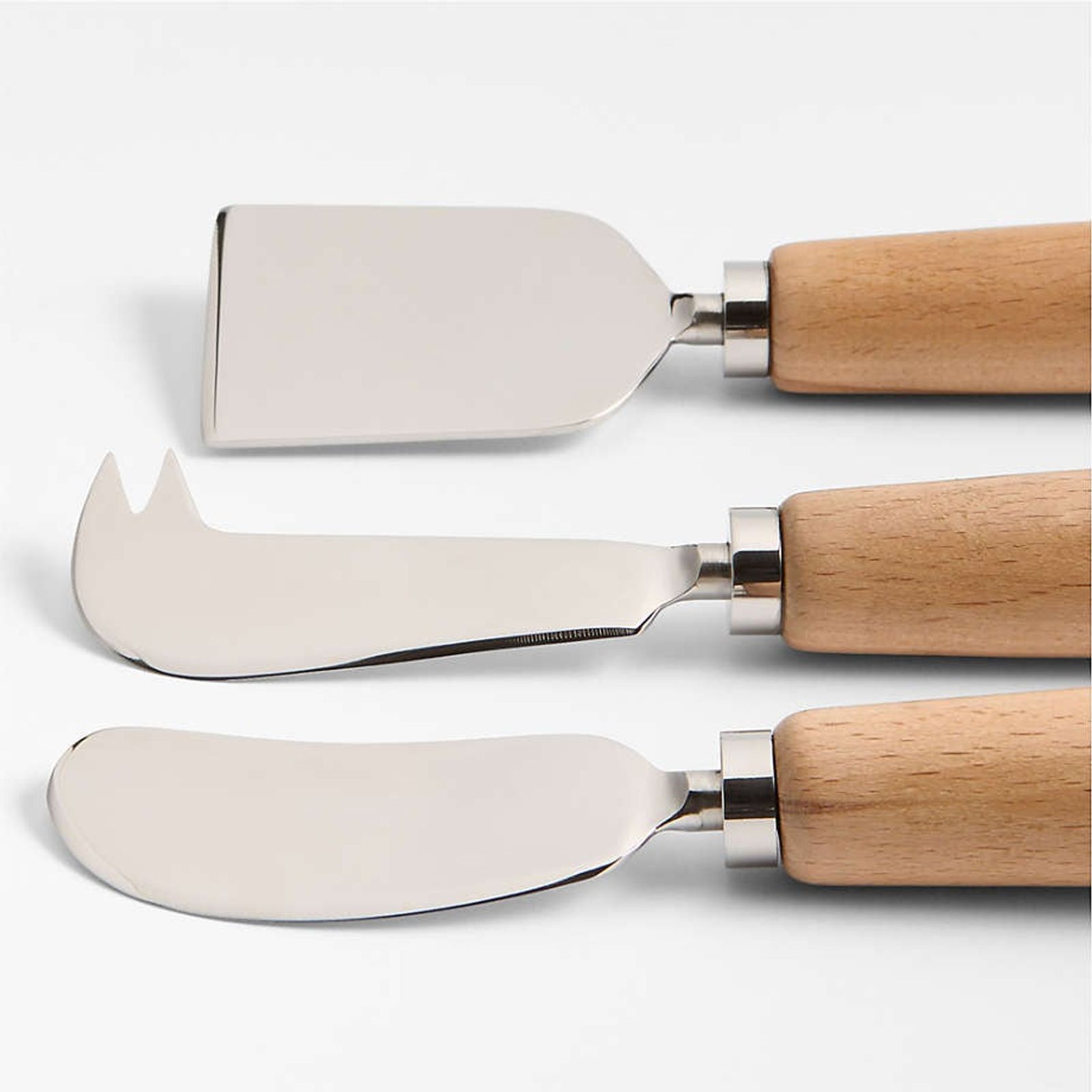 Cheese knives on a marble board with berries
