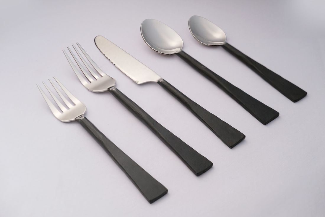 Matte black-handled stainless flatware place setting