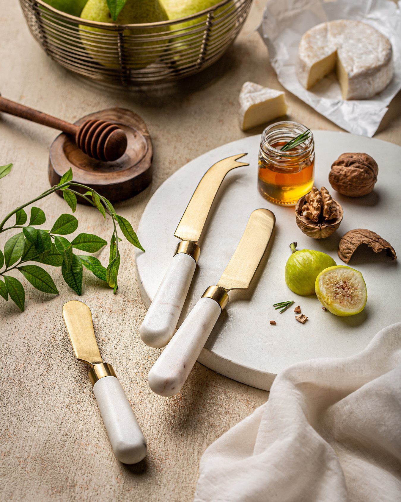 Brass-handle cheese knife styled with honey and figs