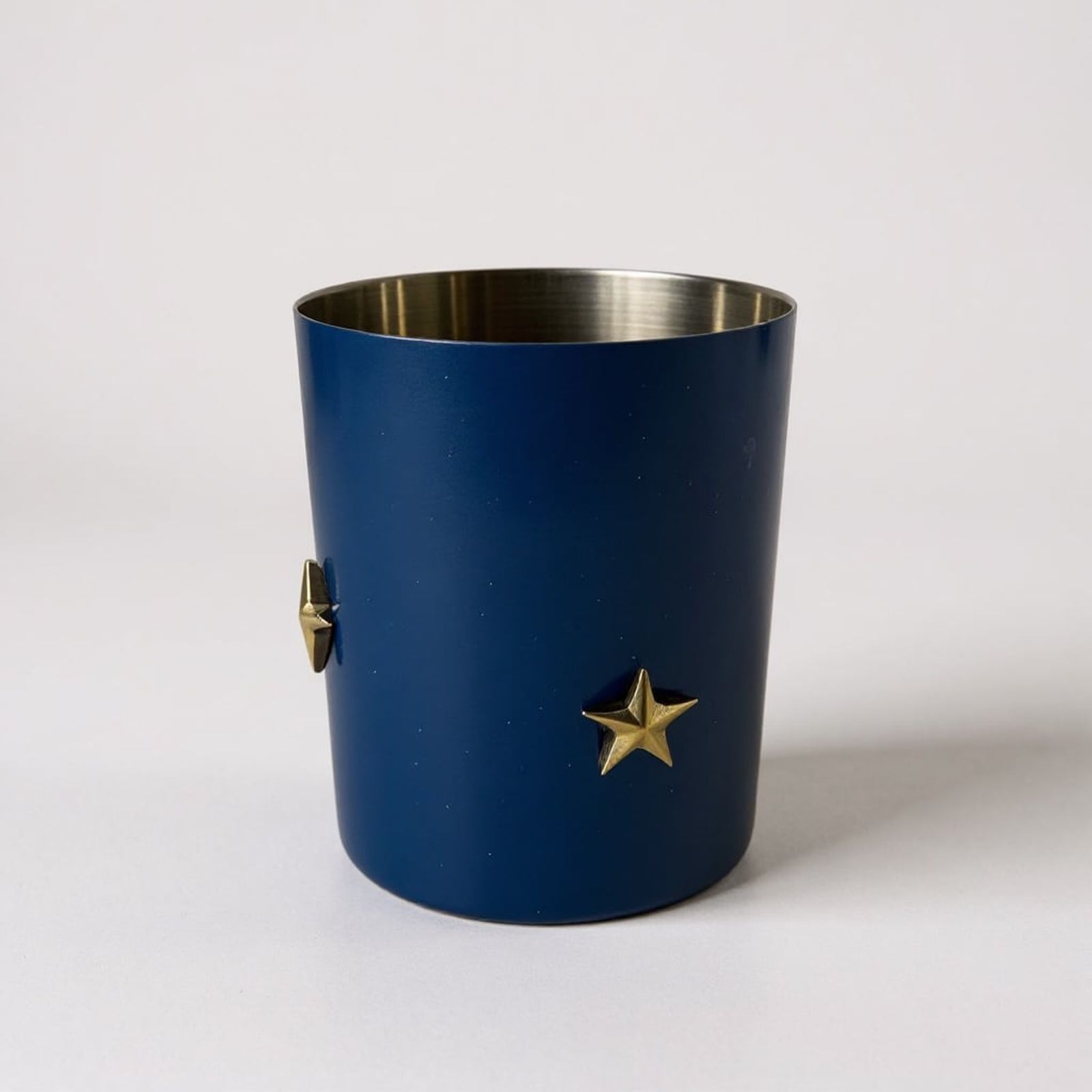 Lidded stainless tumbler — a vessel that reuses as drinkware once repoured