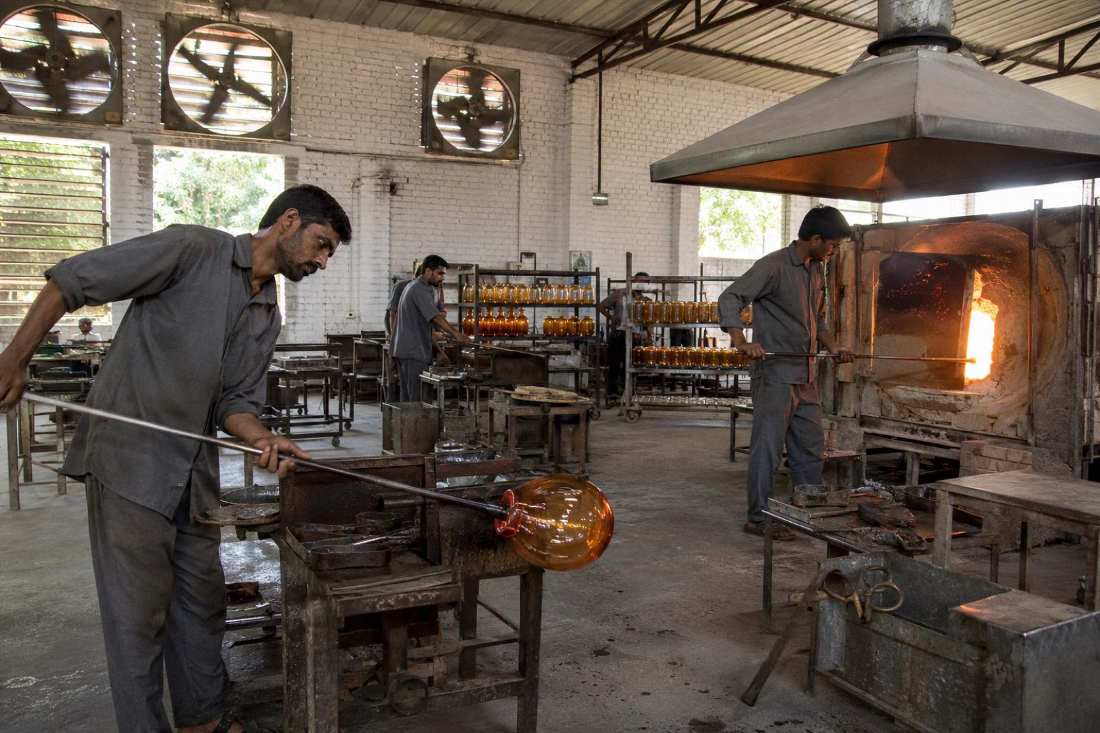 Glassblower shaping molten glass at the Gemixx Firozabad glass hub