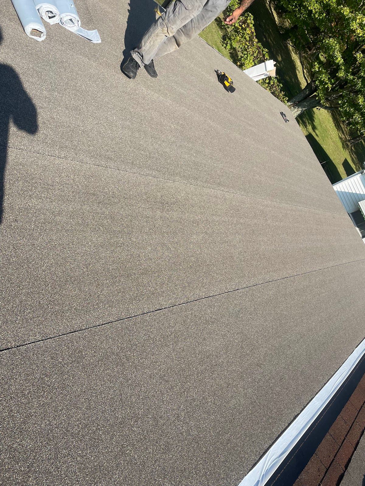 A low-slope roof covered in new rolled roofing