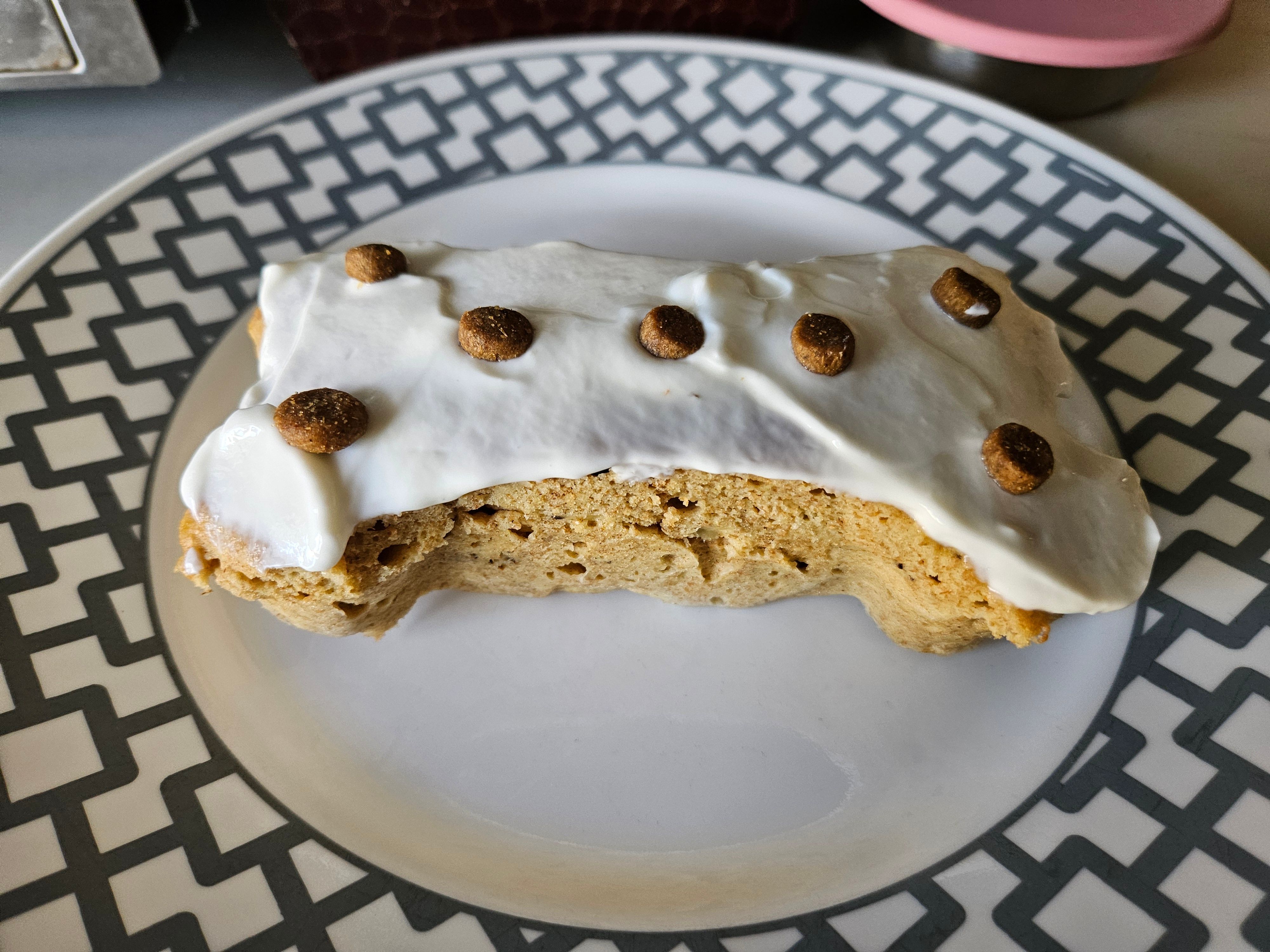 bone shaped pupcake frosted with greek yogurt and topped with kibble pieces