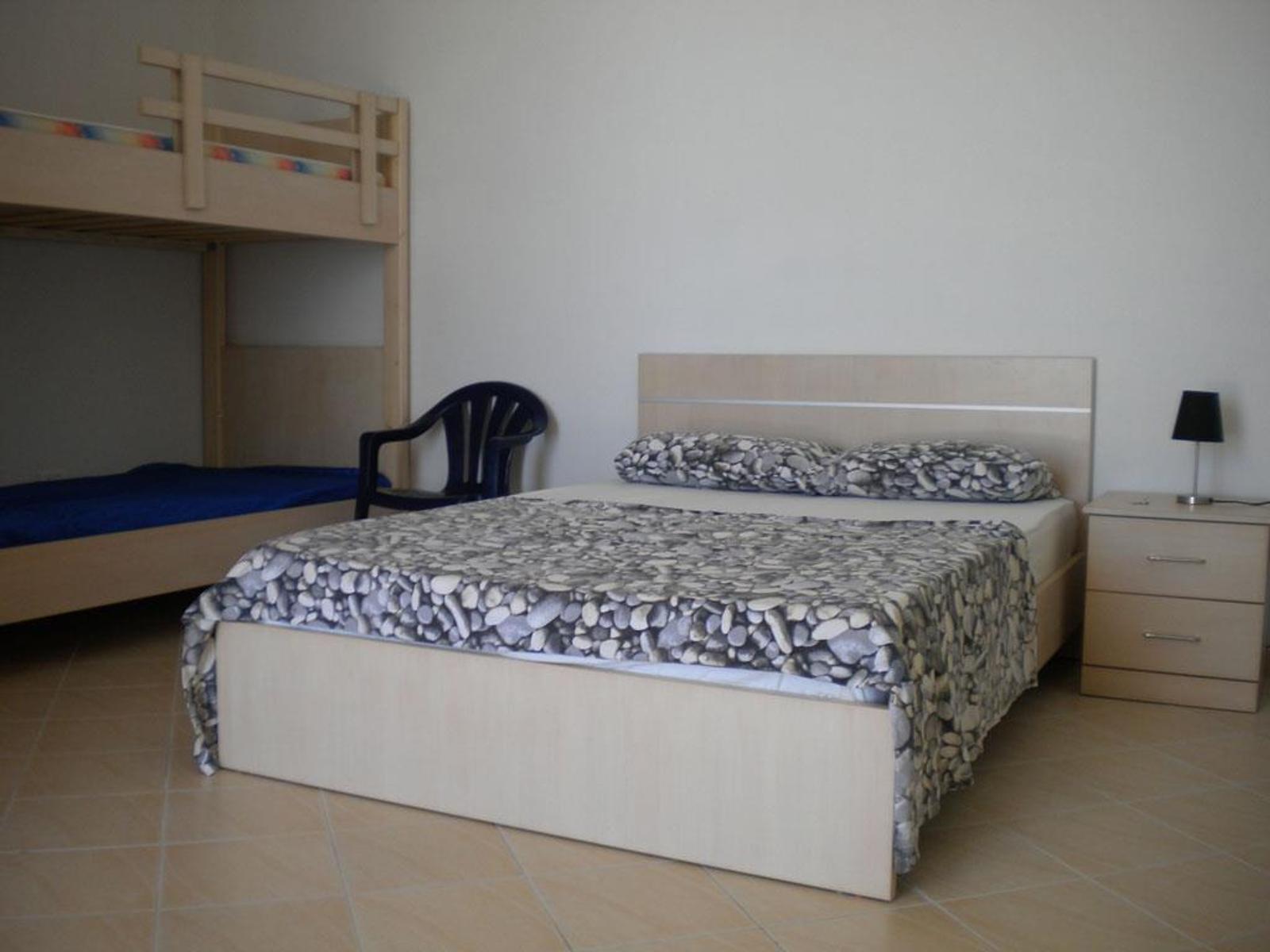One bedroom with double bed and bunk bed