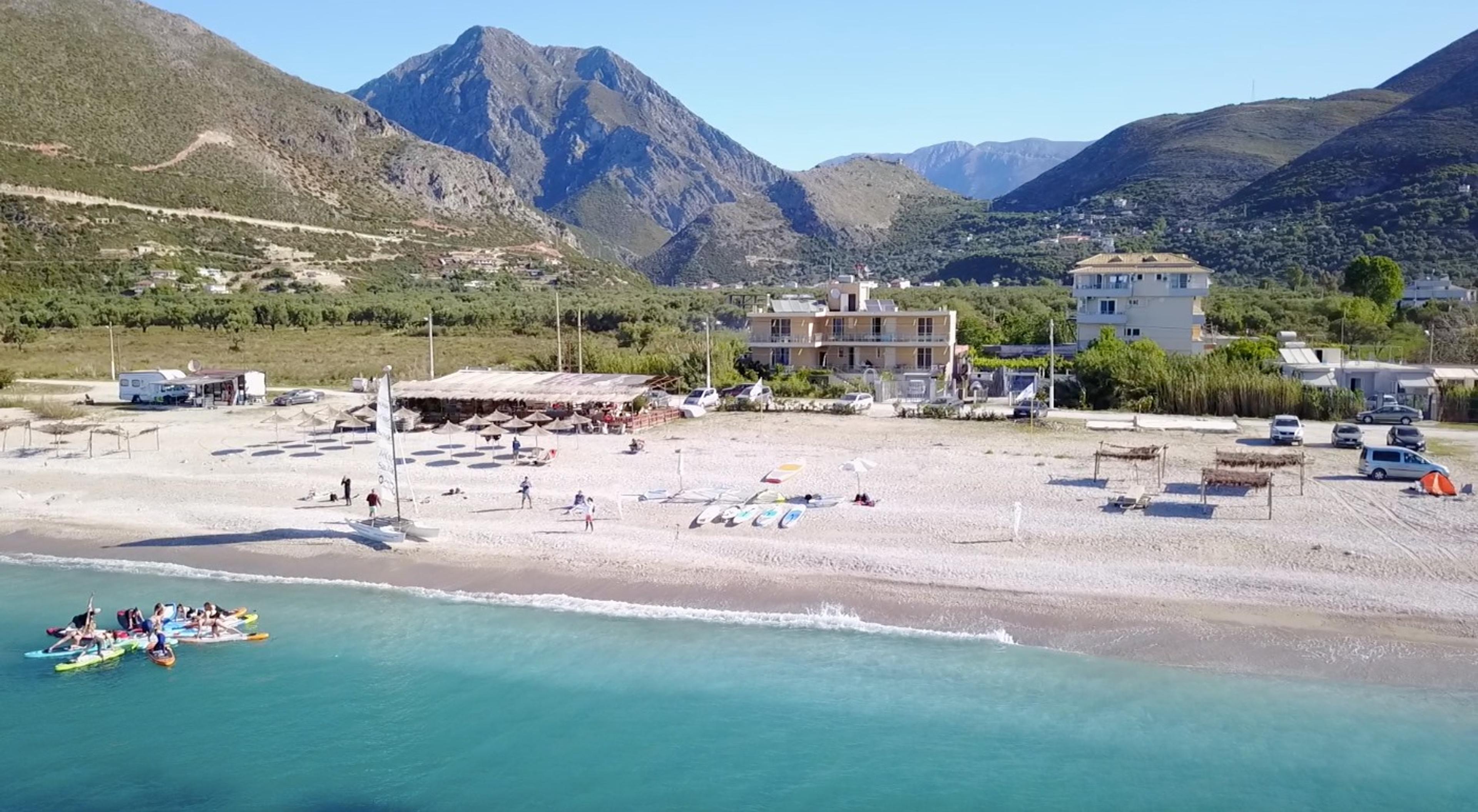 Drone image from the sea with view of the beach and the mountains of Borsh