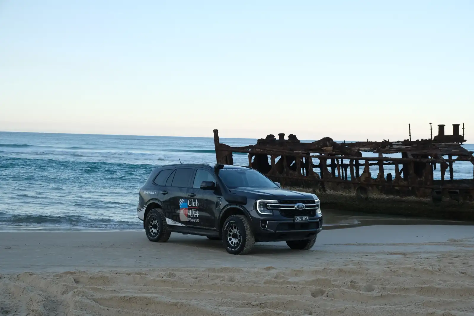 club 4x4 branded ford everest in front of SS Maheno shipwreck on K'Gari
