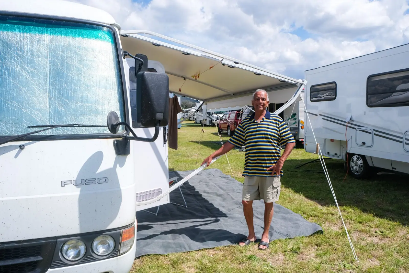 Derek stands with Mitsubishi Fuso Rosa motorhome