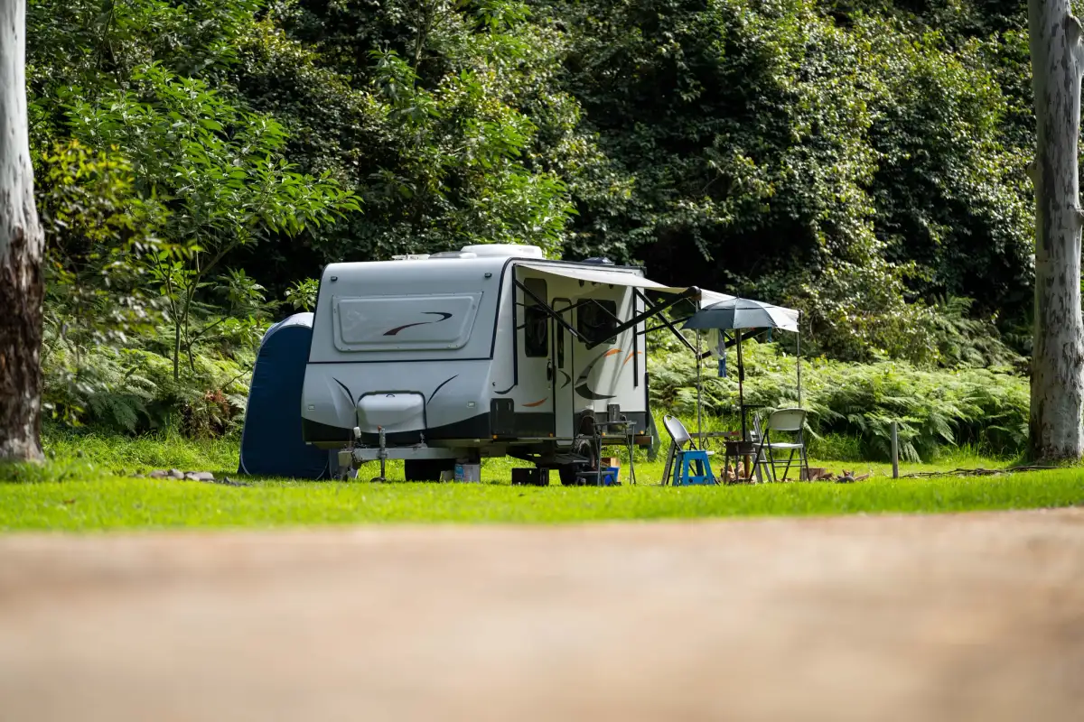 A caravan at a campsite with the awning open