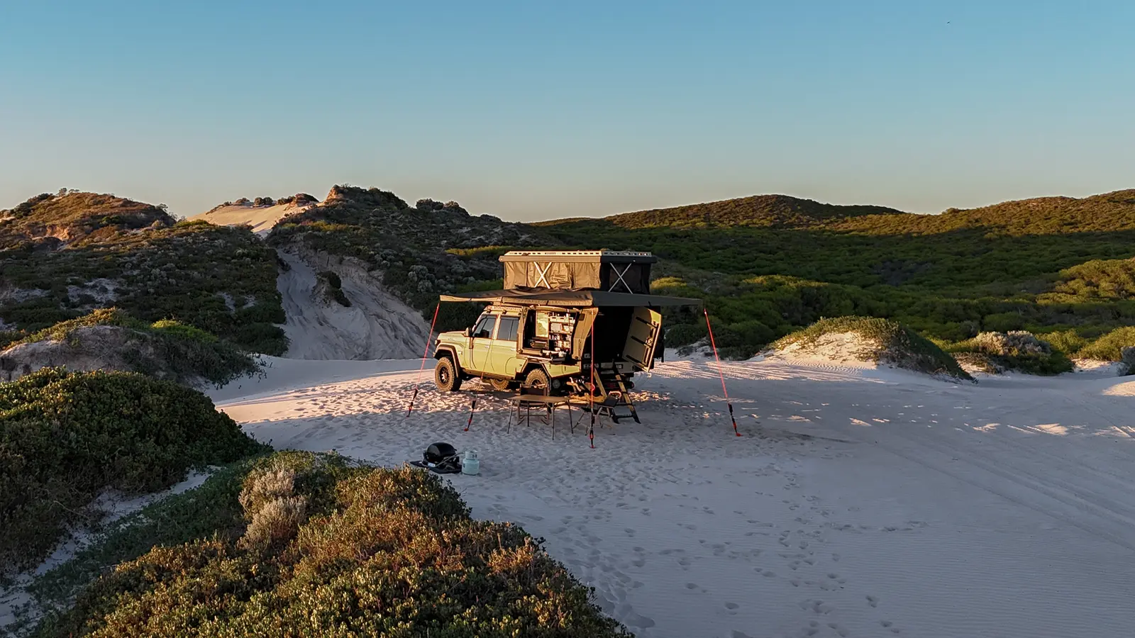 A Toyota LandCruiser 70 Series camped on a beach
