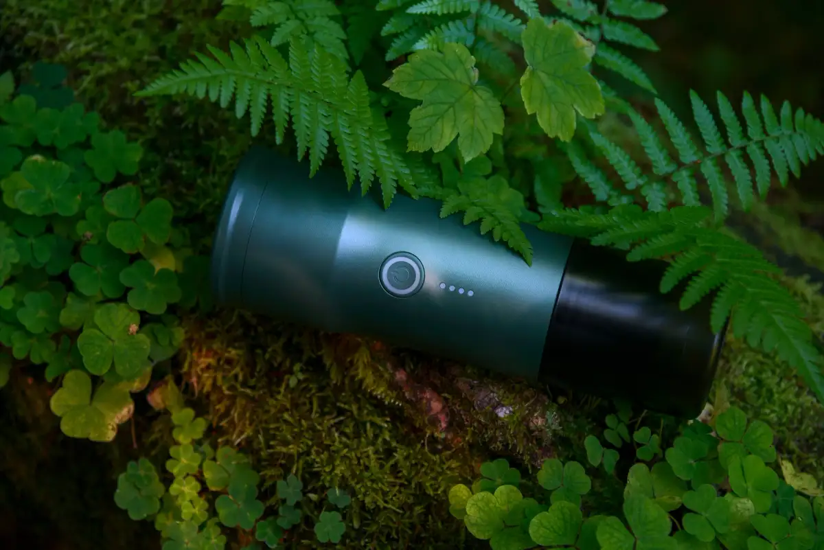 Portable espresso machine pictured in foilage