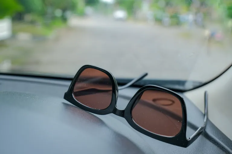 A pair of sunglasses on the dashboard