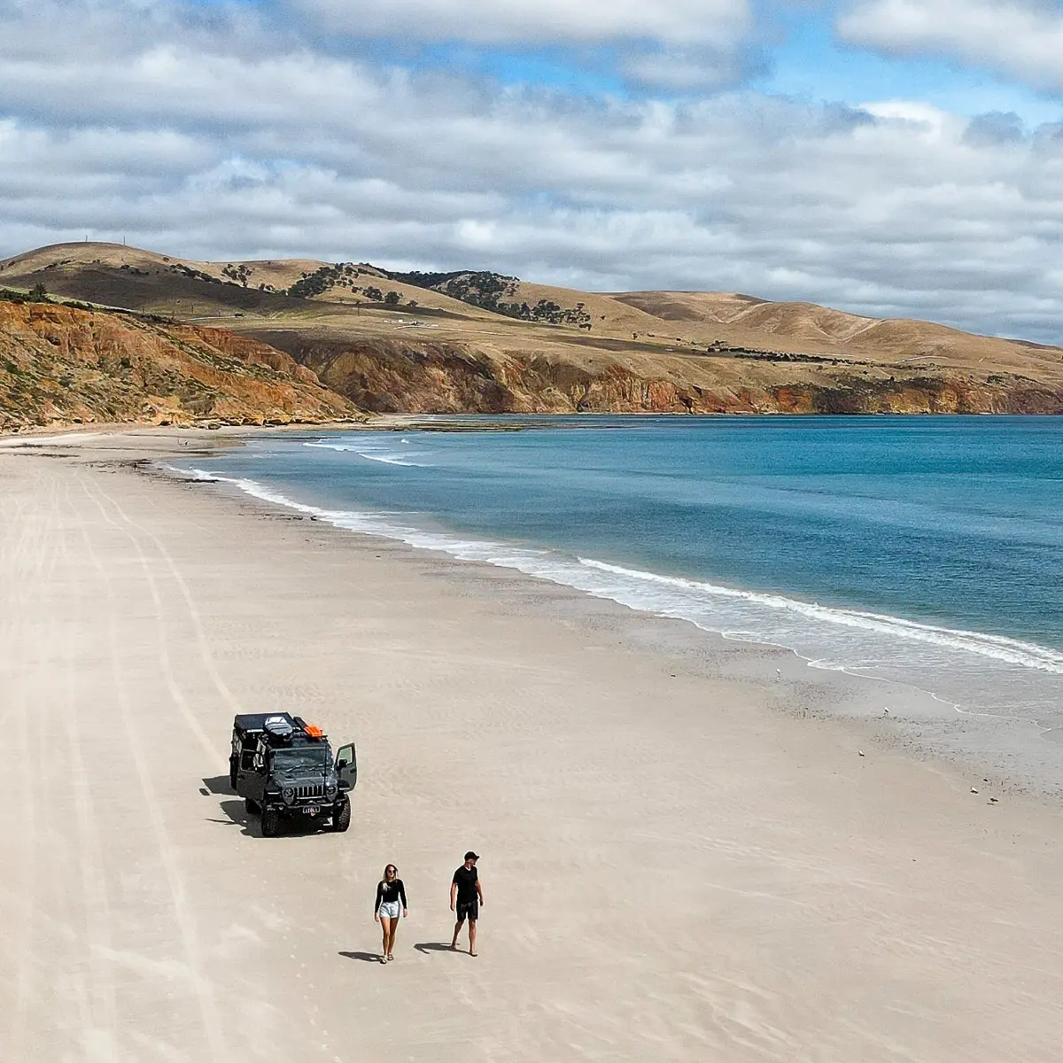 two people and 4x4 on beach