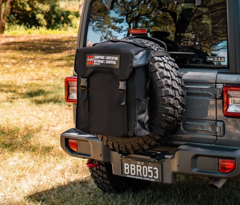 dirty gear bag mounted on a 4X4's spare tyre