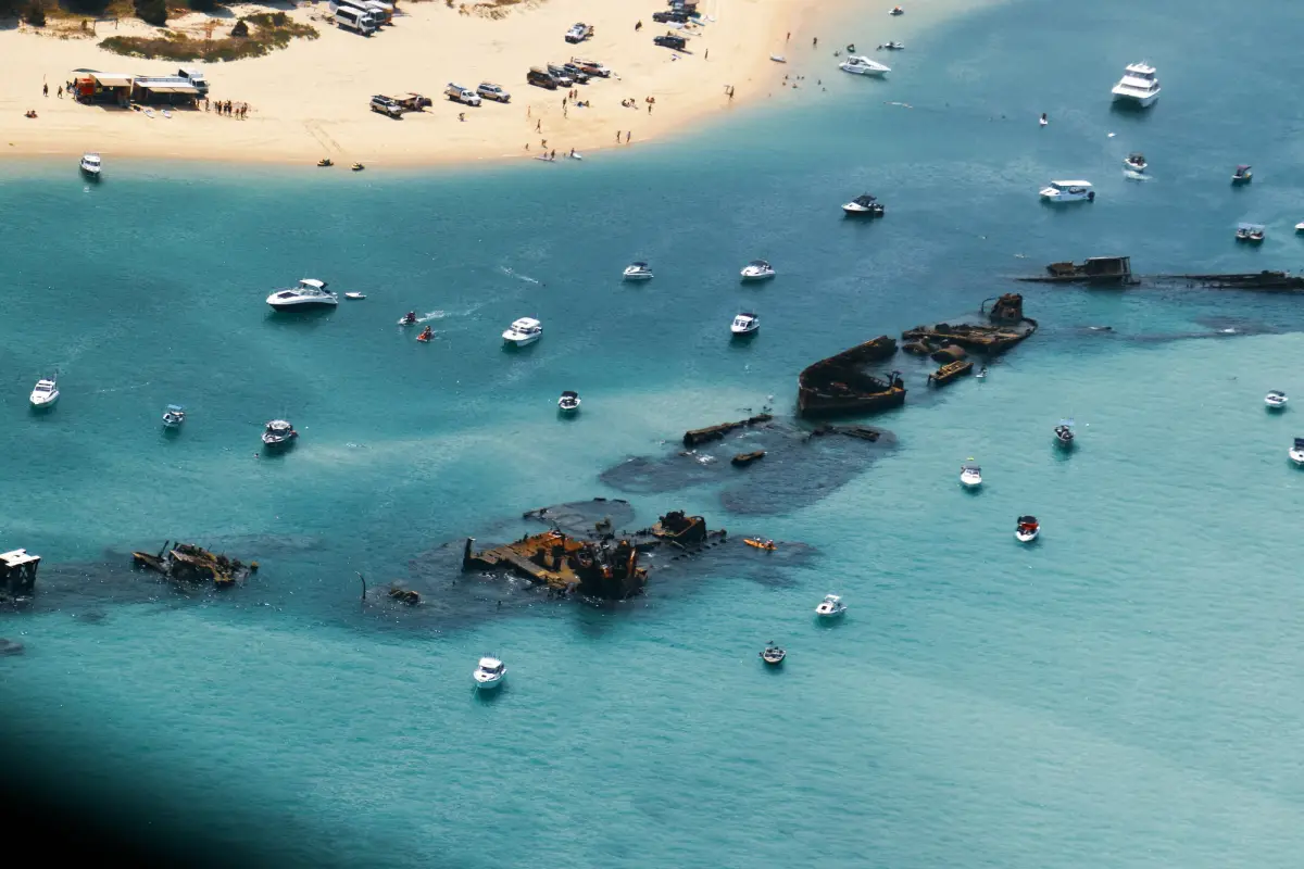 Shipwreck beach with snorkelers on Moreton Island, Australia