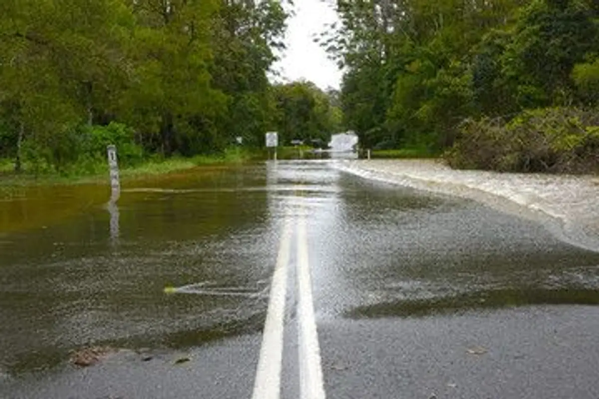 flooded road in australia with flood indicator