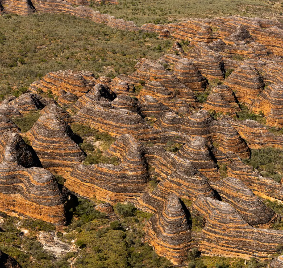 range of red and black streaked mountains in the outback