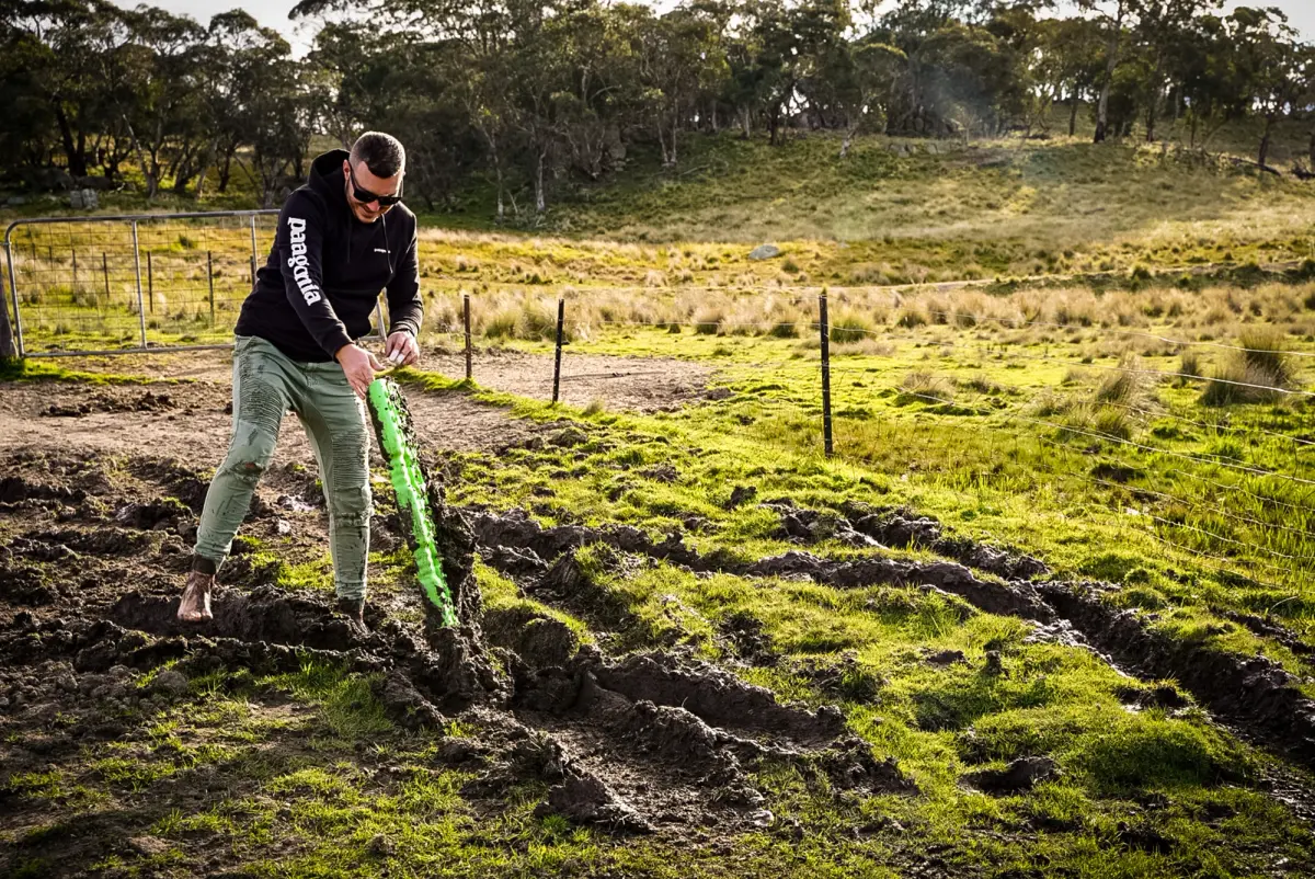 Josh from Adventure Intel Australia digging through mud