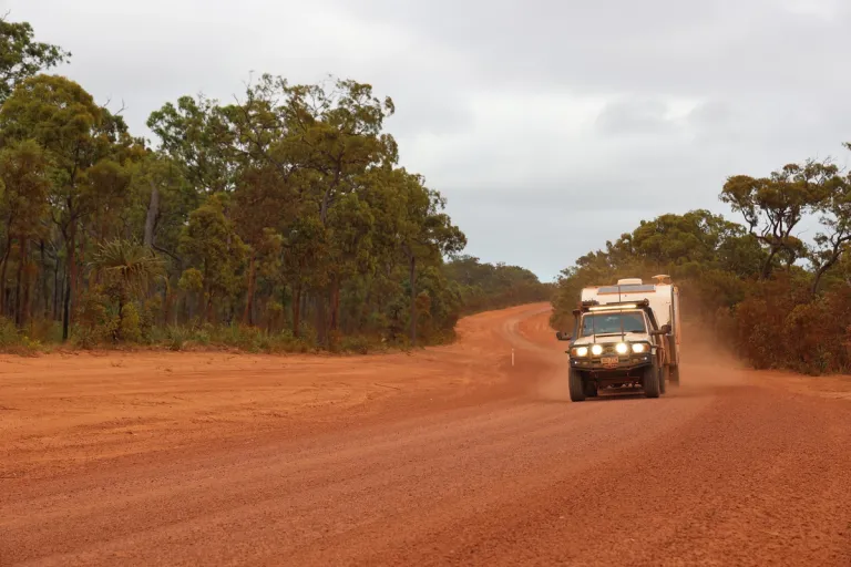 4x4 and caravan driving through gravel road