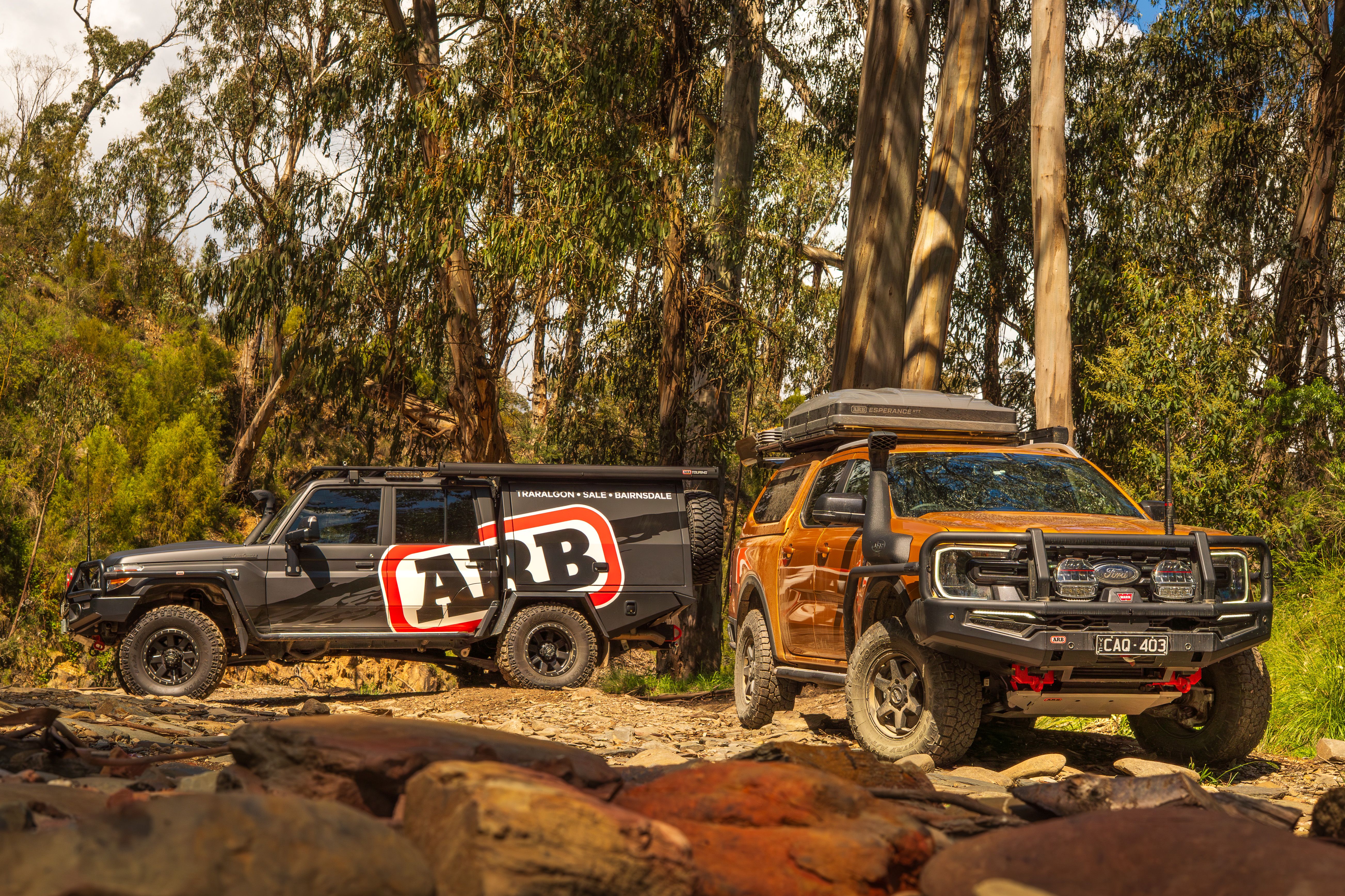 2 4WDs in a forest. One is ARB branded