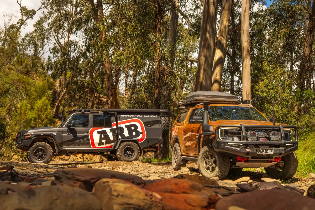 2 4WDs in a forest. One is ARB branded