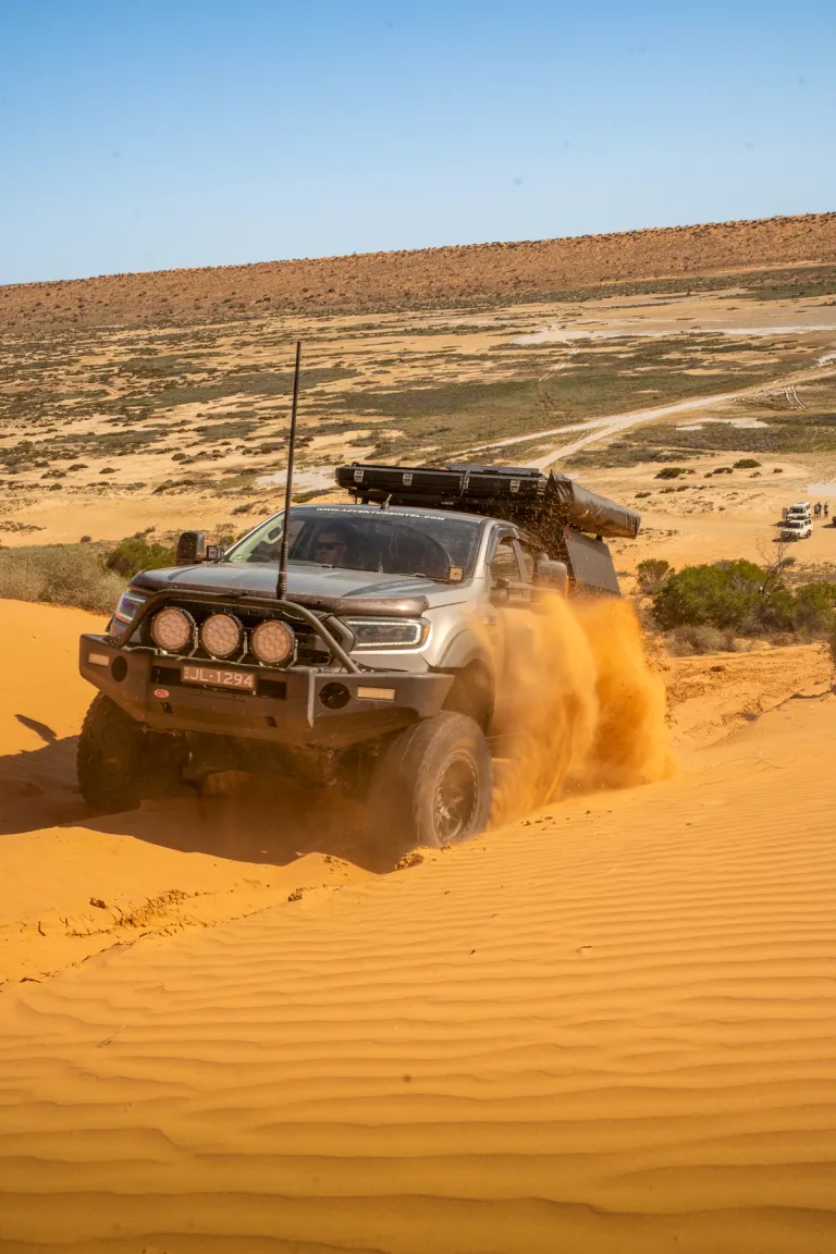 4x4 driving through sand dune