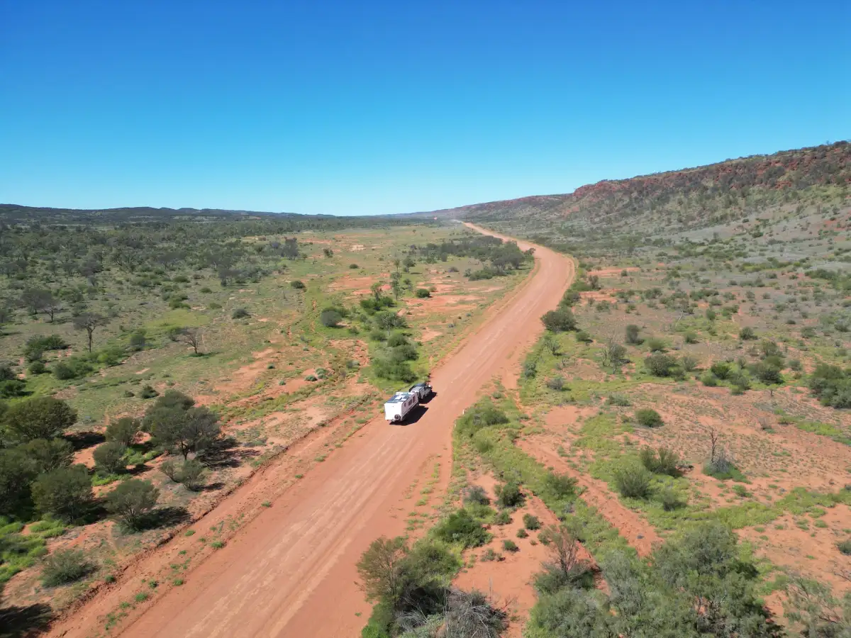 4x4 and caravan driving through arid area