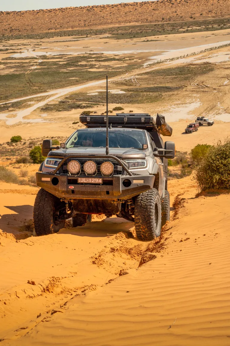 A Ford Ranger 4X4 driving up a sand dune